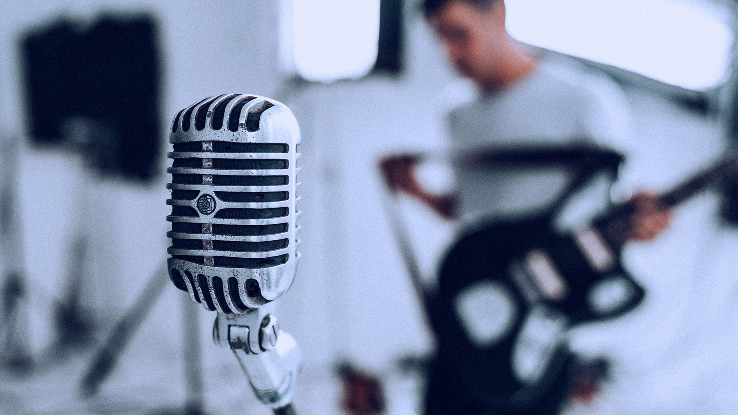 Microphone in foreground of guitarist