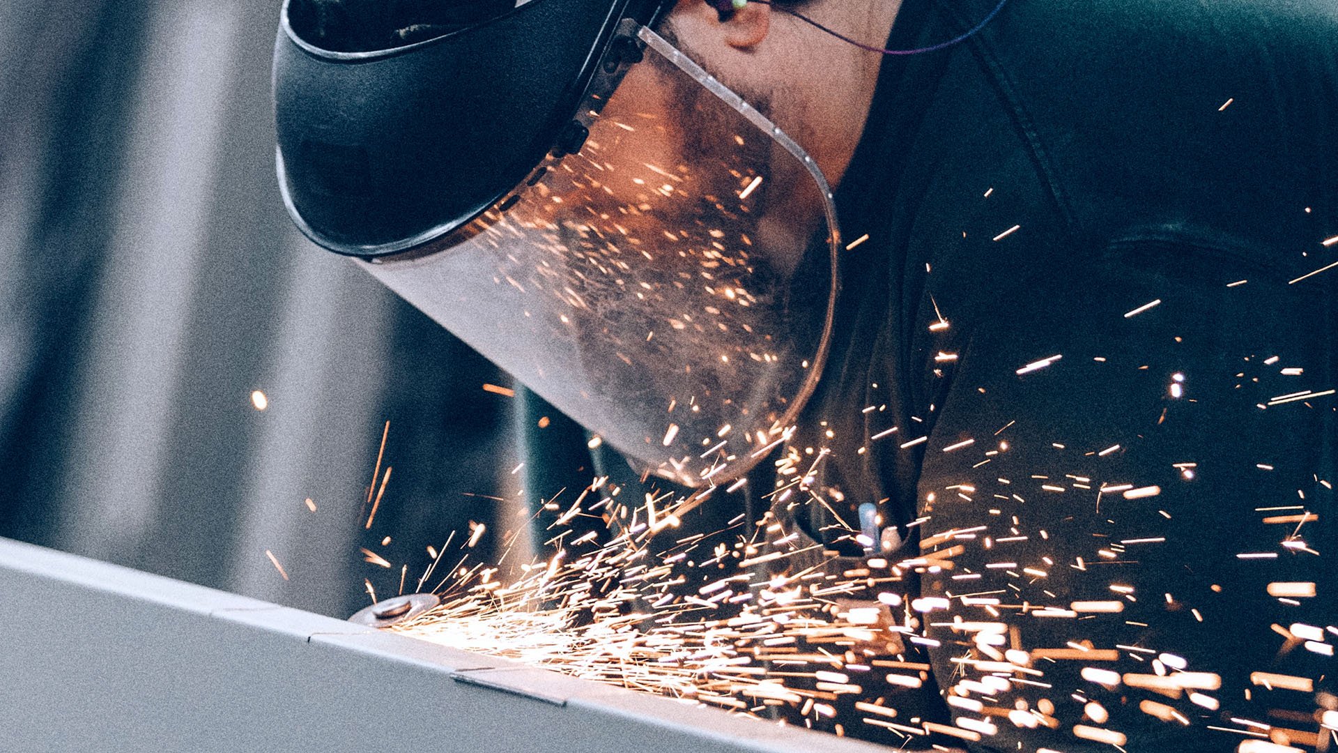 Man welding with sparks flying